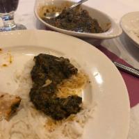Lamb Saag · Tender cubes of lamb cooked with curry spices and spinach. Served with rice.