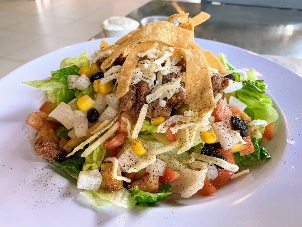 BBQ Chicken Salad · Romaine Lettuce tossed with BBQ Chicken Strips, Black Beans, Corn, Tomato, Jicama, White Cheddar Cheese, Cilantro and tortilla chips tossed in Ranch/BBQ dressing.
