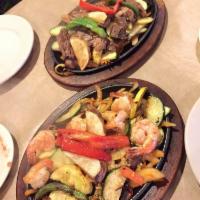 Fajitas · Sizzling with onions, potatoes, and bell peppers. Served with rice, beans, guacamole, pico d...