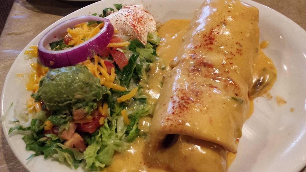 Chimichanga · Filled with shredded chicken or ground beef and Monterey Jack cheese. Topped with sauce. Served with guacamole, sour cream, rice, and beans.