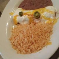 Chicken Enchiladas · Two shredded chicken enchiladas with our famous sour cream sauce. Served with rice, beans an...