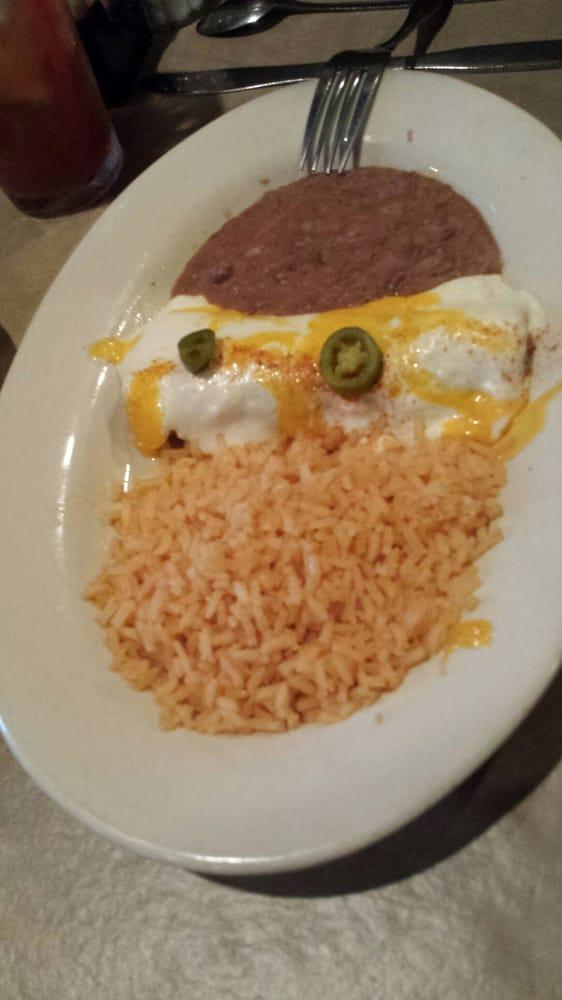 Chicken Enchiladas · Two shredded chicken enchiladas with our famous sour cream sauce. Served with rice, beans and guacamole.