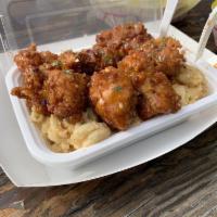 Mac Attack · Hand breaded tenders on a bed of creamy mac and cheese and tots garnished with bacon bits an...