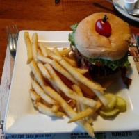 Backyard Burger · Fresh, hand-patted burger on a fresh brioche roll, applewood bacon strips, melted Jack and c...
