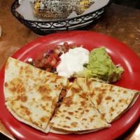Quesadilla · Grilled flour tortilla, choice of 1 filling cheese, guacamole, pico, sour cream and lettuce.