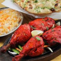 Tandoori Chicken · Spring chicken marinated in masala yogurt for 24 hours and baked in tandoor. Served with bas...