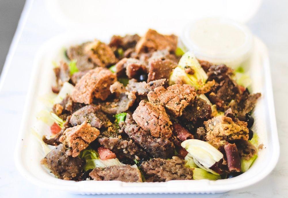 Gyro · Combination lamb and beef with lettuce ,onion, tomato,feta cheese and tzatiki sauce o the side