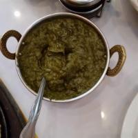 Saag Paneer · Fresh spinach pureed and mixed with chunks of homemade cheese (paneer), cooked with fresh to...
