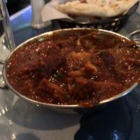 Goat Curry · Goat with bones cooked in tomatoes and onions in punjabi style. Spicy.