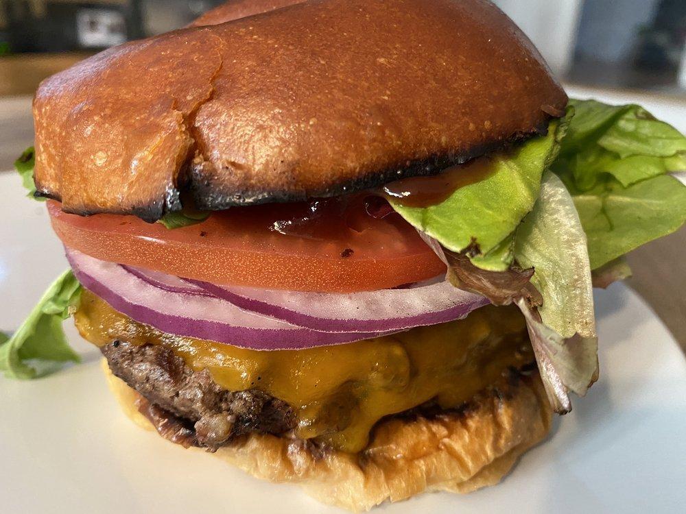 Locksmith Burger · 8 oz. Angus patty with lettuce, tomato, onion, pickles and cheddar. Add avocado or bacon for an additional charge.
