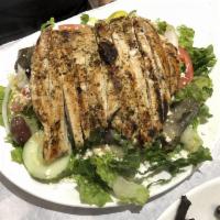 Greek Salad · Lettuce, tomatoes, cucumbers, onions, olives, pepperoncini, dolmades, crumbled feta, and vin...