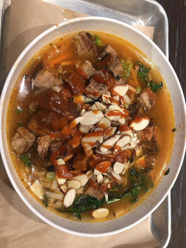 Spicy Ginger Steak and Rice Noodles Bowl · Beef broth, grass fed steak, rice noodles, shredded kale, spicy broccoli, carrots, scallions, sliced almonds, ginger, cilantro and Sriracha.