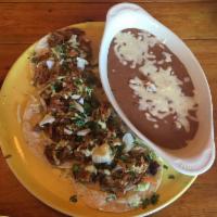 Mango BBQ Pork Tacos · BBQ shredded pork, jalapeno coleslaw, cilantro-lime crema and cilantro.