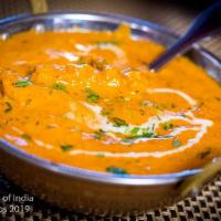 Butter Chicken · Boneless dark chicken roasted in a clay oven and then cooked in a creamy tomato sauce