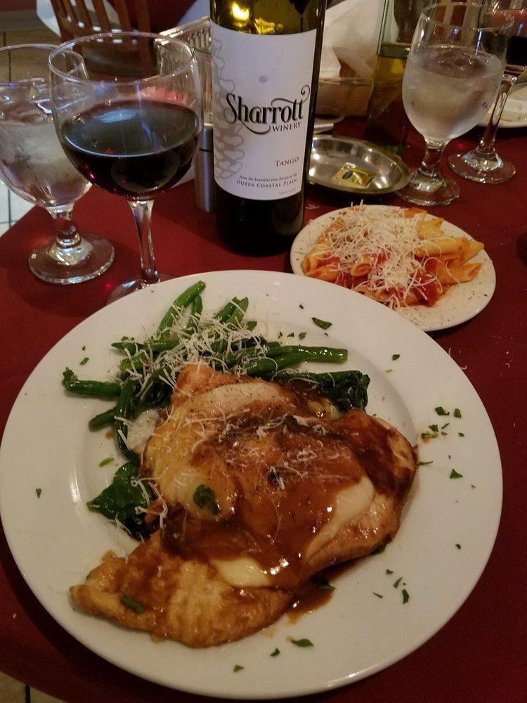 Saltimbocca · Veal or chicken topped with prosciutto, mozzarella and sausage in a wine demi-glaze on a bed of spinach.