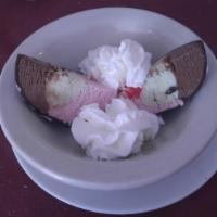 Tartufo · Vanilla and chocolate ice cream with cherries and almonds in a chocolate shell.