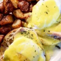 American Classic Egg Benedict · 2 poached eggs, on a grilled English muffin, with smoked ham and topped with Hollandaise sau...