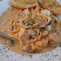 Cajun Seafood Fettuccine · Wild caught shrimp, scallops and salmon sauteed with, mushrooms and garlic in a Cajun white ...
