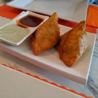Samosa · Deep-fried crispy pastry turnover filled with potatoes, peas, spices and herbs served with c...