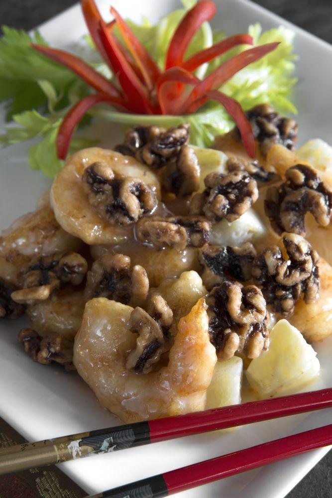 Honey Walnut Shrimp · Crunchy jumbo shrimp tossed with pineapple chunks, glazed in a light lemon cream sauce and topped with a generous serving of candied walnuts. 