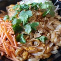 Chicken Pad Thai · Rice noodles in tangy pad Thai sauce with green onions, carrots, cilantro, egg, peanuts, and...
