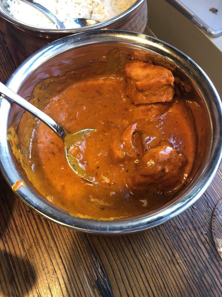 Chicken Tikka Masala · Chicken breast marinated in spices and yogurt, baked in the tandoor oven and cooked in a creamy onion and tomato sauce.