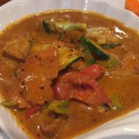 Panang Curry · Light sweet curry in coconut milk with bell peppers and carrots, topped with kaffir lime lea...