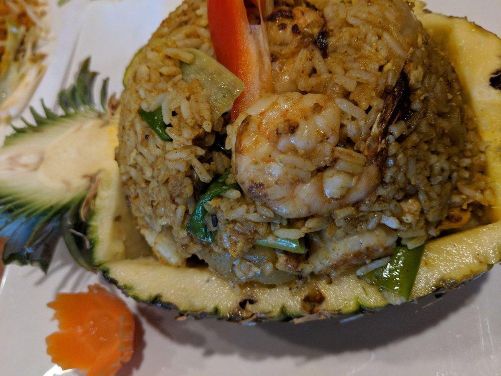 Pineapple Fried Rice · Fried rice with combination of chicken, shrimp, pineapple, cashew nuts, onions, scallions and egg. Spiced with curry powder. Served in pineapple shell.