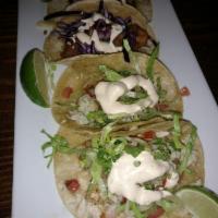 Modelo Battered Fish Taco · Purple cabbage, chipotle crema and lime. Served on authentic homemade nixtimal corn tortilla...