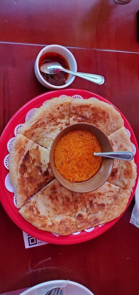 Balada · Burmese crispy pancake with curry dipping sauce.