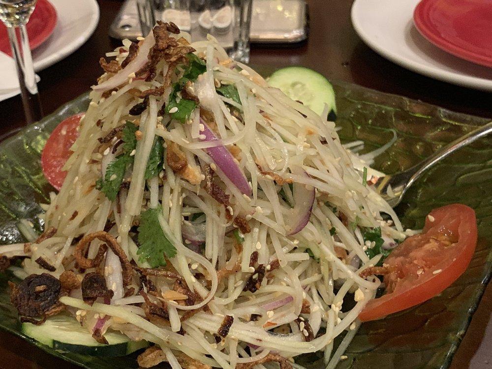 Green Papaya Salad · Shredded green papaya, cucumber, green pepper, onion, grounded shrimps, fried garlic and grounded peanut with dressing. Hot and spicy.
