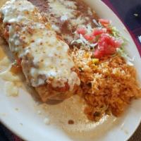 Chimichanga · Fried burrito with choice of chicken or steak, sour cream, guacamole, ranchera sauce on top ...