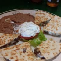 Steak Quesadilla · Pan seared flour tortilla with mozzarella cheese & steak. Includes a side of refried beans a...