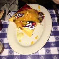 Frito Pie · A bag of Fritos with your choice of smoked beef brisket chili or veggie chili topped with ch...