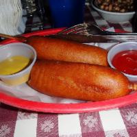 Corn Dogs · 2 corn dogs served with mustard and catsup.