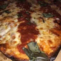 Grandma Pie · Thin crust square pizza with mozzarella, basil, marinara sauce and sprinkled with grated Par...