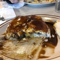 Loco Moco · Bed of steamed rice, brown gravy, beef patty, over easy eggs all topped off with extra gravy.