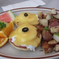 Eggs Benedict · two Poached eggs on English muffin, Canadian bacon, topped with hollandaise sauce & fruit. h...