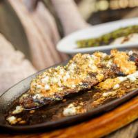 Fiery Feta Flank Steak · Grilled flank steak topped with our famous fiery feta crumble. Served with a side of garlic ...