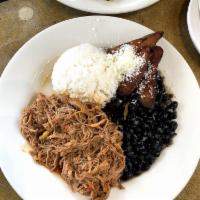 Pabellon · Venezuela’s national dish. Shredded beef cooked in a tomato-based sauce with red peppers, on...