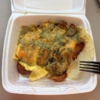 Huevos Rancheros · Crispy corn tortillas topped with spicy chorizo sausage, black beans, onions, cheddar cheese...