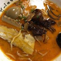 Mayu Garlic Ramen · Pork belly chashu, cubed pork stew, fried garlic, crunchy black mushroom, bean sprouts, gree...