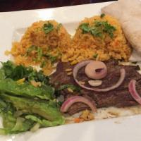Carne Asada · Grilled seasoned outer skirt steak. Served with rice, beans, tortillas and avocado.