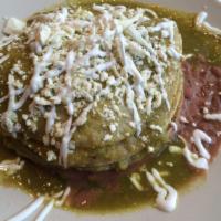 Huevos Nortenos · Tortillas topped with beans, chorizo, scrambled eggs and green sauce, drizzled with queso fr...