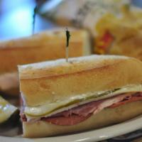 Famous Po' Boy · Corned beef, pastrami, salami, turkey, Swiss cheese and kosher pickles on a homemade roll. S...
