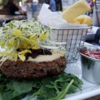 The Impossible Burger · Seared plant based impossible patty with honey caramelized onions, hummus, alfalfa sprouts a...