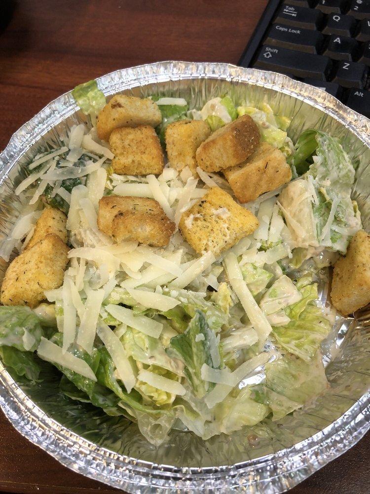 Caesar Salad · Romaine lettuce tossed with a Caesar dressing topped with homemade croutons and shaved pecorino Romano cheese.