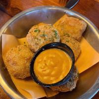 Poblano Corn Fritters · Crispy golden fried poblano creamed corn served with our house dipping sauce.