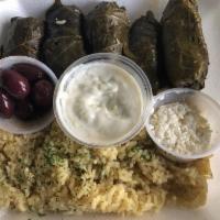 Dolmathes · 6 homemade grape leaves served with feta cheese, Kalamata olives, and rice pilaf, and pita b...
