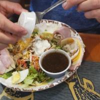 State Road 44 Chef Salad · Fresh mixed greens accompanied by thinly sliced turkey, ham and Swiss cheese topped with qua...